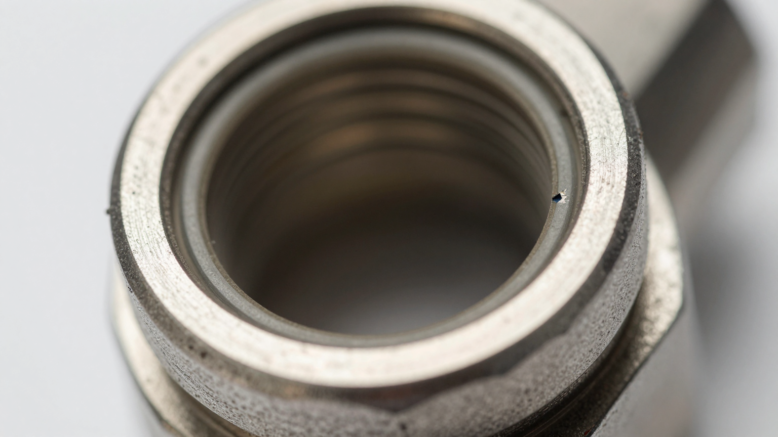 A technician examining the quick disconnect fittings on a personal cooling suit vest.